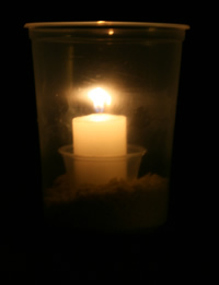 Clear bucket with lit candle